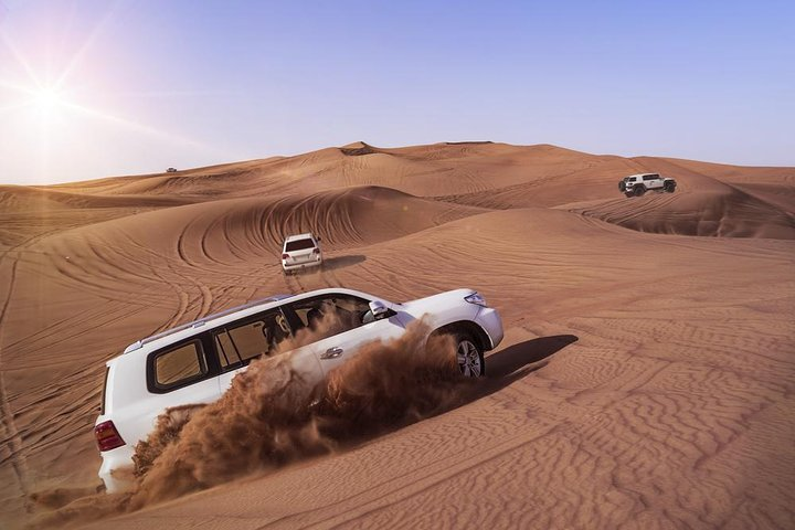 Experience the thrill of barreling over golden sand dunes in a luxury 4x4 surrounded by the stunning expanse of the desert under the warm sun. Enjoy every moment!